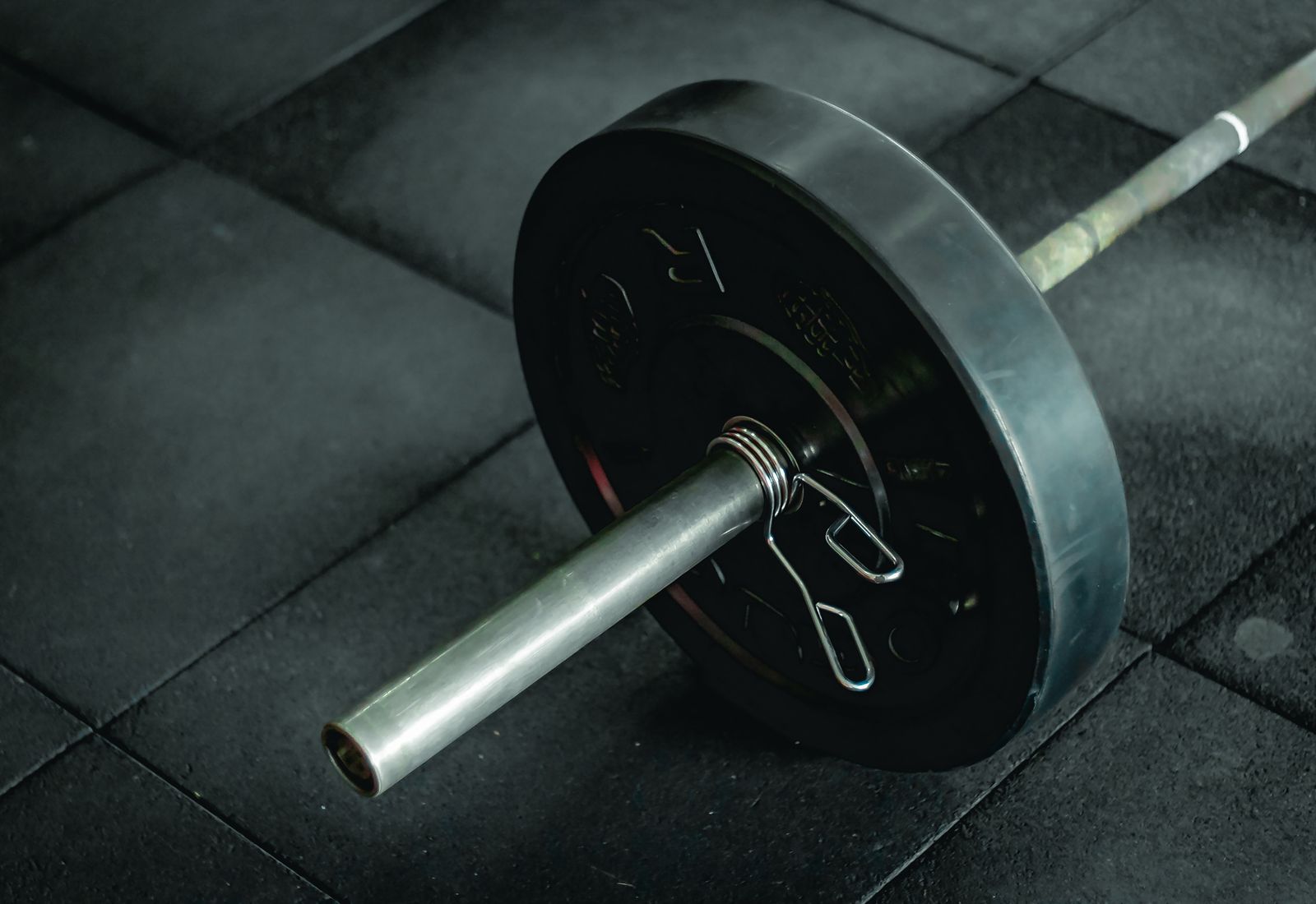 A loaded barbell on the gym floor at Forge Athletic Club