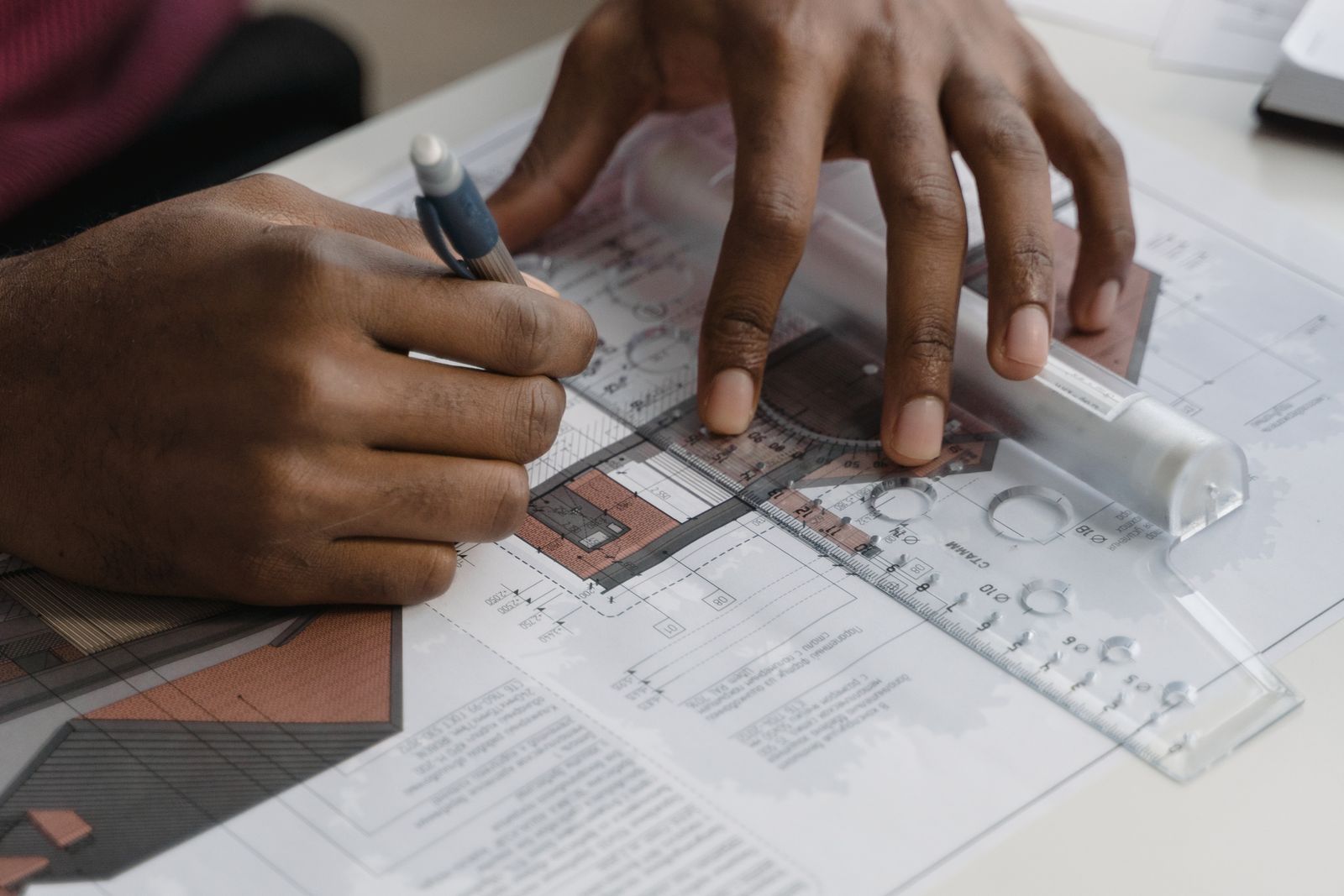 A Stonebrook architect drafting floor plans by hand with pencil and straightedge
